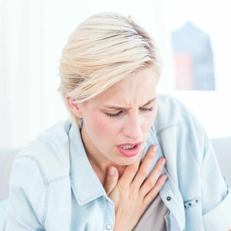 A woman suffering from shortness of breathe, a common symptom of iron deficiency