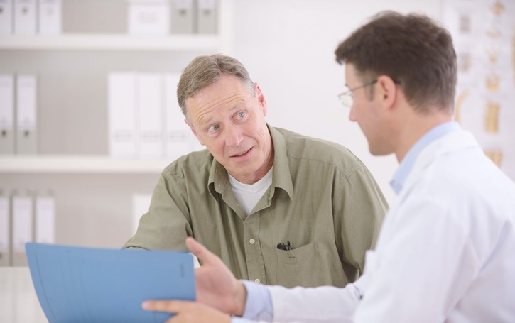Male patient in his 50s asking doctor about prostate cancer screening test in Solitaire Medical Group, Adelaide.